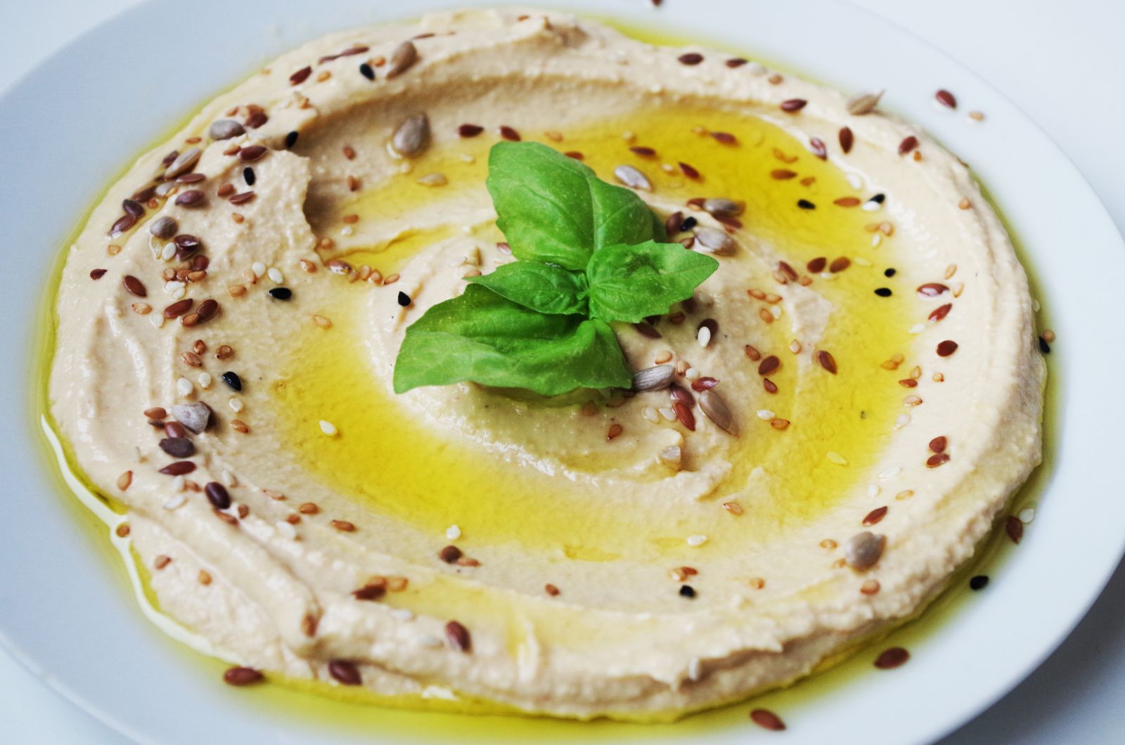 Synchrotron techniques can offer insights into which chickpea crops will perform best before they are produced on a mass scale for cattle. (Pictured is a plate of hummus garnished with basil.)