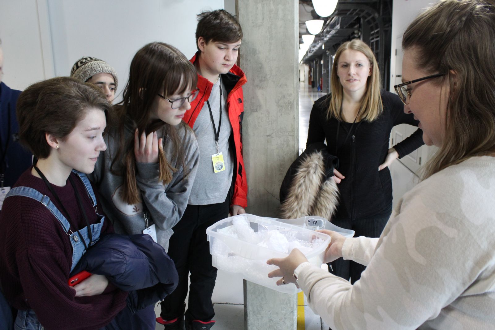 Students looking at an user sample as part of a career talk with their field trip with a light source student experience (LiSSE) at CLS.