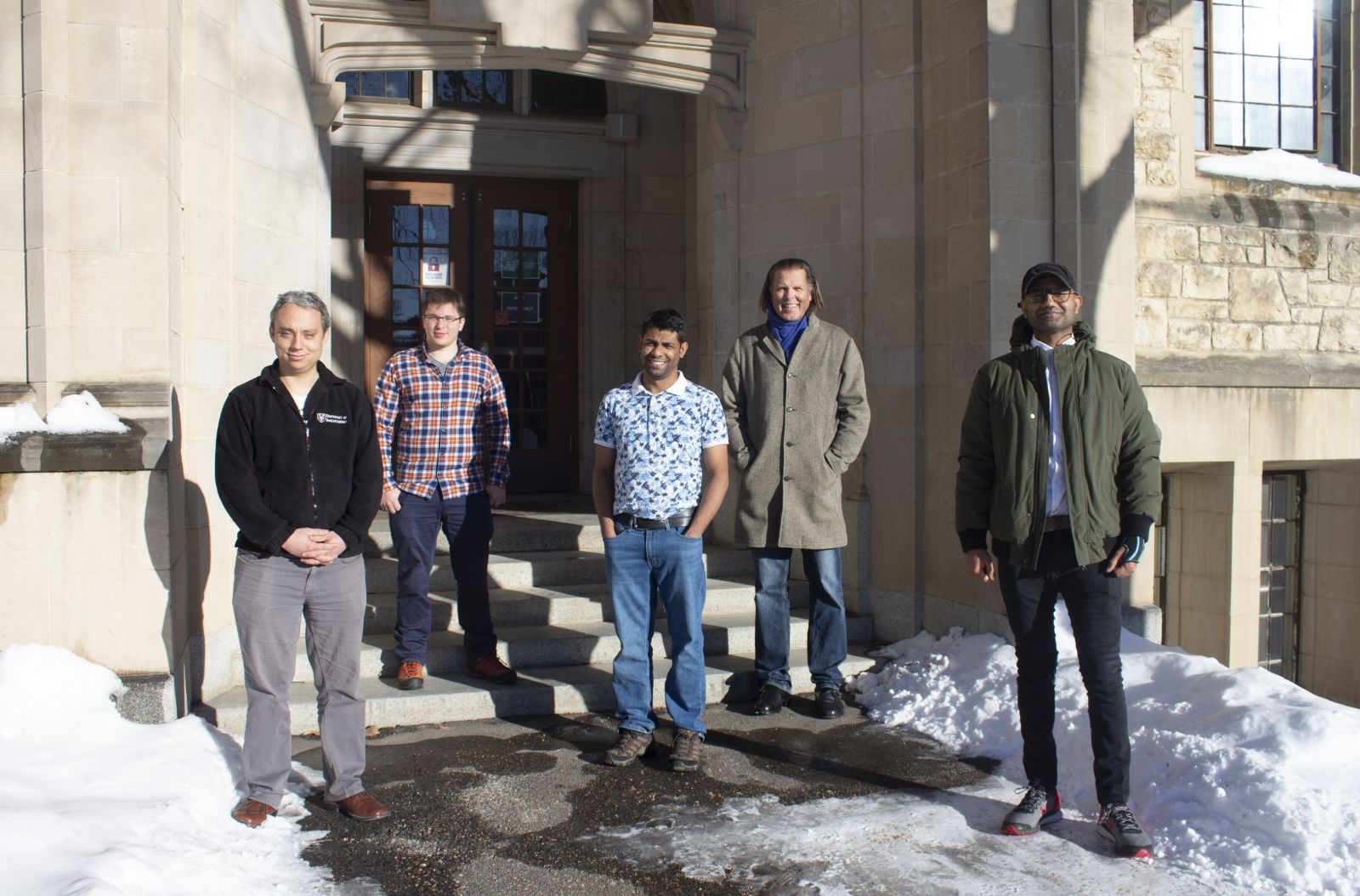 (Left to right) Tristan de Boer, Patrick Braun, Ruhul Amin, Alexander Moewes and Amir Qamar outside the Physics building at USask.