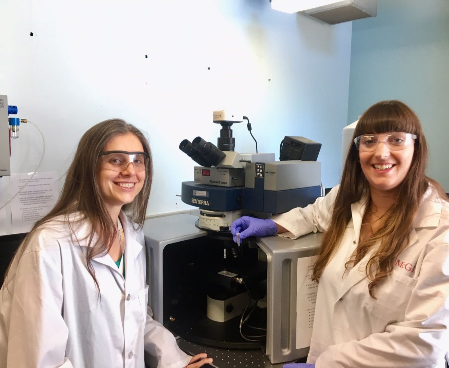 Marta Cerruti (left) and Ophelie Gourgas in a laboratory using a Raman machine.