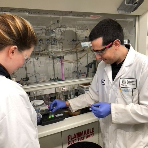 Rondeau-Gagne (right) and Mooney working with a dye precursor and their electroactive polymers (in solution).