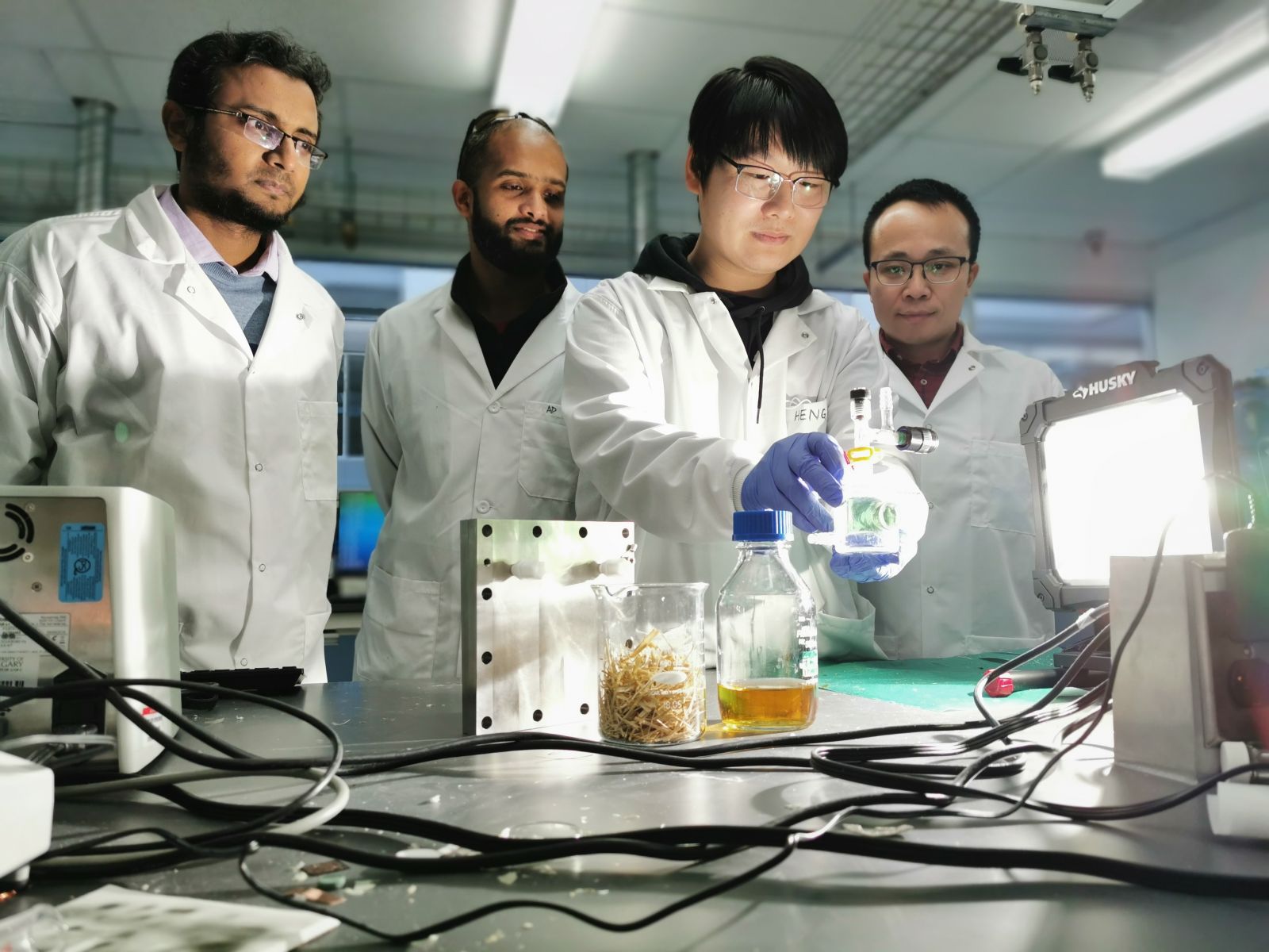 The UCalgary team is observing a photo-reactor that is being used for a photoreforming reaction with wheat straw. Left to right: Prof. Md Golam Kibria, Dr. Adnan Khan (Research Associate), Dr. Heng Zhao (Post doctoral fellow), Prof. Jinguang Hu. Credit: Prof. Hu and Kibria group.