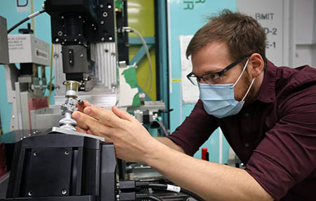 Toby Bond adjusts a battery sample on the BMIT beamline.