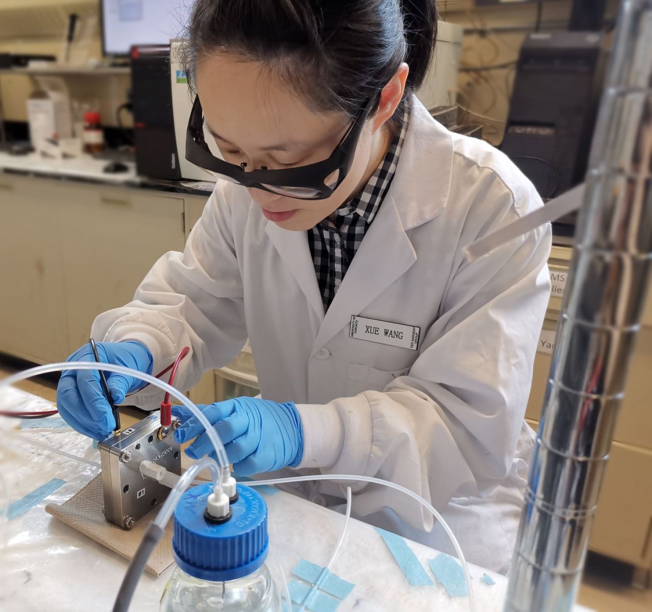 Xue Wang installing a membrane electrode assembly MEA cell for testing the performance of the N-CCu catalyst in CO2RR.